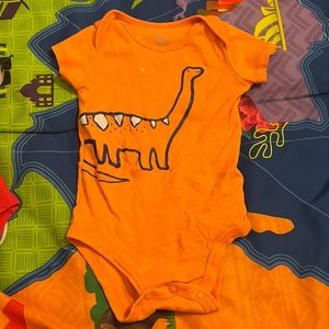 Orange dinosaur onesie
